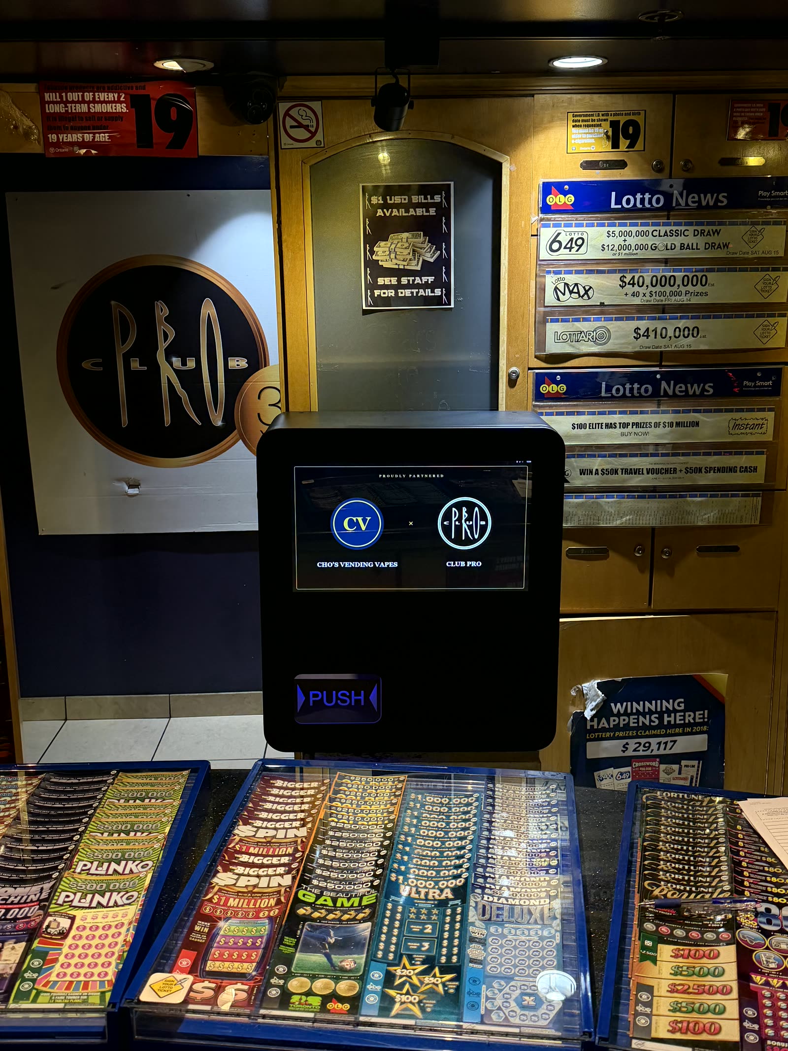 Close view of the staff-operated Cho's Vending machine at Club Pro — dispense bin and partnership screen