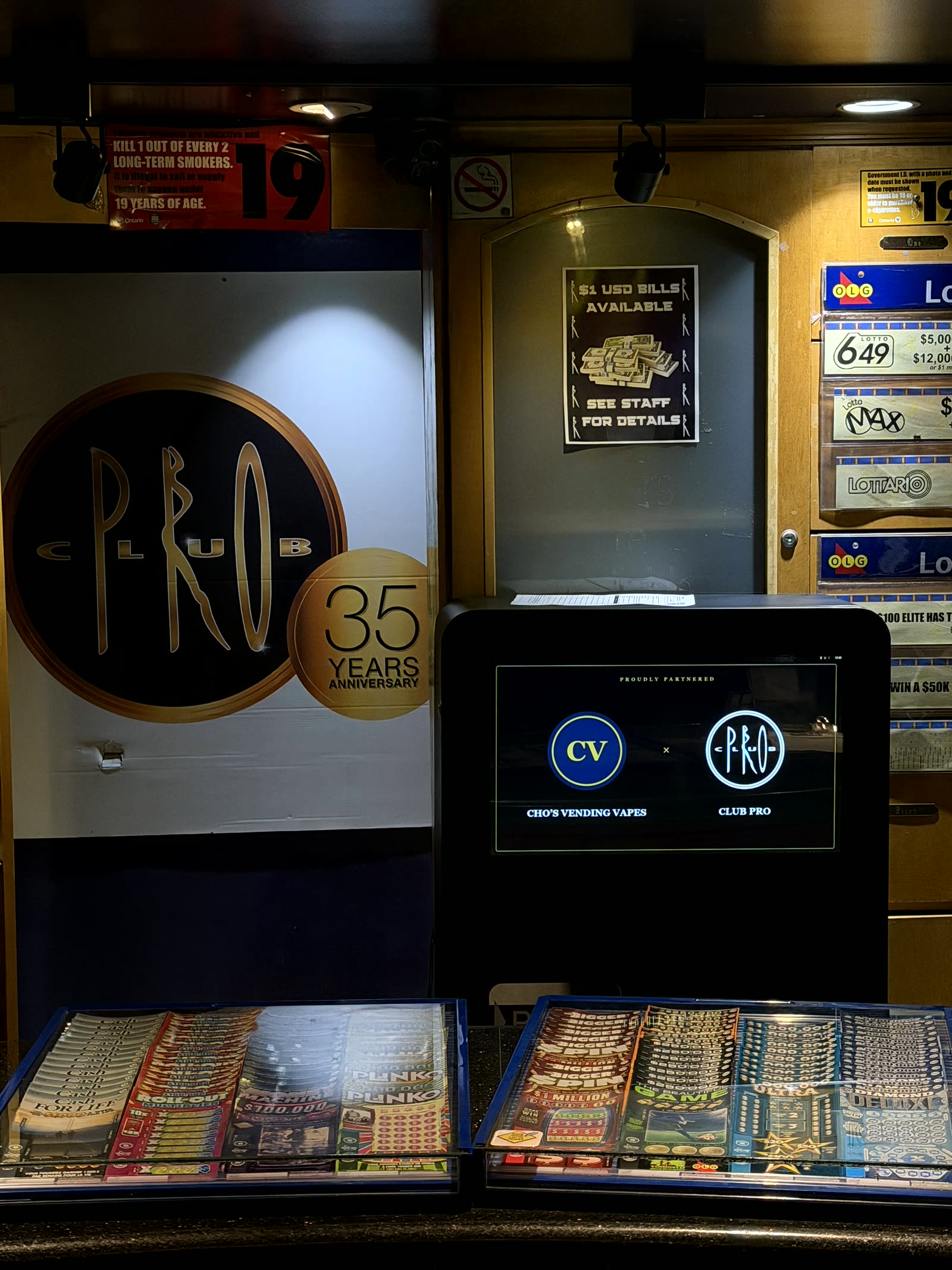 Cho's Vending machine live behind the counter at Club Pro, Vaughan — co-branded standby screen with 19+ signage
